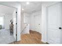 Bright hallway with wood floors and white doors leading to various rooms, enhancing the home's open and airy feel at 4222 Acorn St, Charlotte, NC 28205