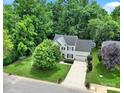 Aerial view of home showcases the meticulously landscaped yard, mature trees, and long driveway at 488 Saint George Rd, Fort Mill, SC 29708