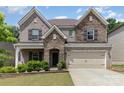Beautiful two-story home with a stone and brick facade, complemented by a manicured lawn and attached two-car garage at 5098 Burnwald Ct, Fort Mill, SC 29715