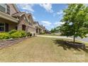 Charming home exterior with a well-manicured lawn, mature tree, and a neatly landscaped yard in a suburban neighborhood at 5098 Burnwald Ct, Fort Mill, SC 29715