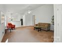 Bright living room with neutral walls, plush carpet, and ample space for seating, ideal for relaxation and entertainment at 611 Annalinde Ln, Rock Hill, SC 29732