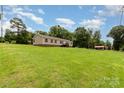 Side view of a single-Gathering home with a spacious front yard and mature trees, providing a peaceful setting at 828 Carver St # 17-19, Shelby, NC 28152
