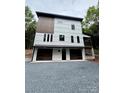 Modern two-story home showcasing white siding, dark window trim, and a two-car garage at 908 Apex Dr, Albemarle, NC 28001
