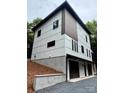 Modern two-story home showcasing white siding, dark window trim, and a two-car garage at 908 Apex Dr, Albemarle, NC 28001