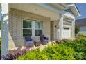 Inviting front porch with seating area, columns, and lush landscaping at 9226 Dunwich Dr, Gastonia, NC 28056