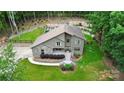 Aerial view of a well-kept property with a stone facade, black fence, lush green lawn, and backyard garden at 9423 Man O War Rd, Fort Mill, SC 29707