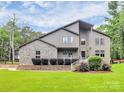 Charming two-story home featuring a stone facade, well-maintained lawn, and inviting entryway at 9423 Man O War Rd, Fort Mill, SC 29707