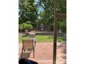 View from the screened porch to the peaceful backyard with a brick patio and a lovely water feature at 964 Knob Creek Ln, Fort Mill, SC 29708