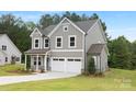 Stylish two-story home with gray siding, a well-maintained lawn, and a two-car garage, offering modern curb appeal at 9858 Jack Nicklaus Dr # 897, Lancaster, SC 29720