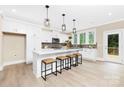 Bright kitchen with white cabinets, a large island with seating, and stainless steel appliances at 9858 Jack Nicklaus Dr # 897, Lancaster, SC 29720