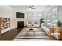 Bright, staged living room with fireplace, hardwood floors, and modern decor at 103 Margo Ln, Statesville, NC 28677