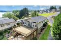 Rear elevated deck with lake view, overlooking a grassy yard with mature trees at 111 Trails End Ln, New London, NC 28127