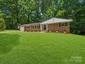 Charming brick home with a lush green lawn and beautiful landscaping at 1123 Timberlane Dr, Lincolnton, NC 28092
