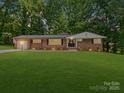 Charming brick home with a lush green lawn and beautiful landscaping at 1123 Timberlane Dr, Lincolnton, NC 28092