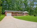 Brick home with attached garage, spacious driveway, and a well-manicured lawn at 1123 Timberlane Dr, Lincolnton, NC 28092