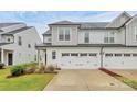 Charming home with white exterior, dark roof, and three-car garage at 13022 Rover St, Charlotte, NC 28273