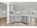 Charming kitchen with gray cabinets, stainless steel appliances and lots of natural light at 13022 Rover St, Charlotte, NC 28273