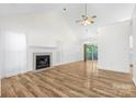 Bright living room features wood floors, a fireplace, and sliding glass doors at 131 Canopy Ct, Mooresville, NC 28115