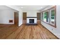 Bright living room with fireplace, hardwood floors, built-ins, and large windows for natural light at 132 Windy Hill Rd, Statesville, NC 28625