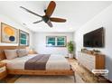 Light-filled bedroom featuring hardwood floors, a ceiling fan, neutral walls, and a large window at 132 Windy Hill Rd, Statesville, NC 28625
