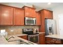 Spacious kitchen featuring stainless appliances, wood cabinets, and granite countertops at 14411 Glendon Hall Ln, Charlotte, NC 28262
