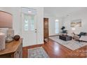 Inviting foyer with hardwood floors, a decorative front door, and a view into the bright living area at 16013 Wynfield Creek Pkwy, Huntersville, NC 28078