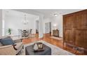 Open living space featuring hardwood floors, neutral decor, and easy access to the dining area at 16013 Wynfield Creek Pkwy, Huntersville, NC 28078