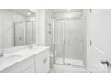Bright bathroom featuring double vanity, frameless glass shower with tile surround and bench at 1708 Braemar Village Dr, Monroe, NC 28110