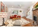 Bright living room features hardwood floors, fireplace and comfortable seating at 1912 Baxter St, Charlotte, NC 28204