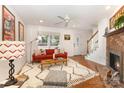 Bright living room features hardwood floors, fireplace and comfortable seating at 1912 Baxter St, Charlotte, NC 28204