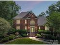 Charming two-story brick home with manicured lawn and landscape at twilight at 2769 Independence Way, Gastonia, NC 28056