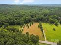 Expansive property featuring a mix of wooded areas and open fields, perfect for outdoor activities and enjoying nature at 2831 Puetts Chapel Rd, Bessemer City, NC 28016
