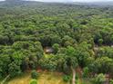 Secluded home nestled within a dense forest, offering privacy and tranquility in a lush, natural setting at 2831 Puetts Chapel Rd, Bessemer City, NC 28016