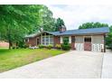 Attractive brick home featuring a covered parking area and lush landscaping, ready for move-in at 2836 20Th Street Ne Ln, Hickory, NC 28601