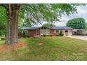 Brick home features a well-manicured lawn and beautiful landscaping, creating a welcoming entrance at 2836 20Th Street Ne Ln, Hickory, NC 28601