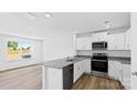 Modern kitchen with stainless steel appliances, granite counters, and wood floors at 3140 Ora Smith Rd, Lincolnton, NC 28092
