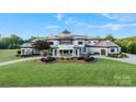 Elegant home featuring manicured lawn and landscaping, circular driveway, and a grand entrance at 355 Pelham Ln, Mooresville, NC 28115