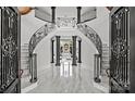 Grand foyer featuring detailed ironwork staircase and marble flooring at 355 Pelham Ln, Mooresville, NC 28115