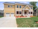 Inviting two-story home showcasing a spacious two-car garage, brick and siding details, and a lush front lawn at 4015 Randolph Rd, Charlotte, NC 28211