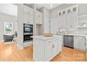 Bright kitchen showcases an island with marble countertop, white cabinetry, and stainless-steel appliances at 4015 Randolph Rd, Charlotte, NC 28211