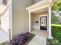 Close-up of the home's front porch with decorative brick accents and a well-manicured garden at 414 1St Avenue Se None, Hickory, NC 28602