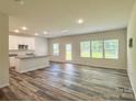 Open living room with a modern kitchen, plenty of natural light, and stylish flooring at 414 1St Avenue Se None, Hickory, NC 28602