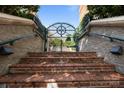 Brick stairs leading to a wrought iron gate at the entrance of this property at 415 N Church St # 311, Charlotte, NC 28202