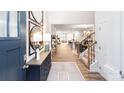 Inviting foyer with staircase, decorative mirrors, and wood flooring, offering a glimpse into the living spaces at 4238 Steel Way, Sherrills Ford, NC 28673