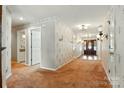 Inviting foyer featuring hardwood floors, elegant wallpaper, and a glimpse of a bright, tiled bathroom space at 441 Wildlife Club Ln, Taylorsville, NC 28681