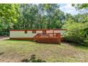 Charming single-story home featuring a wooden deck and lush green lawn at 5239 Lineberger Rd, Stanley, NC 28164