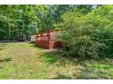 A charming single-story home features a wooden deck and a well-maintained lawn at 5239 Lineberger Rd, Stanley, NC 28164