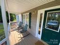 Inviting front porch with rocking chairs, complemented by a stylish green door and detailed trim at 5570 George Henry Dr, Hickory, NC 28602