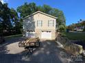 Home with a multi-car garage and ample parking space, complemented by stone accents at 5570 George Henry Dr, Hickory, NC 28602