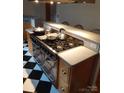Modern kitchen with a stainless steel range and black and white tile floors at 5570 George Henry Dr, Hickory, NC 28602